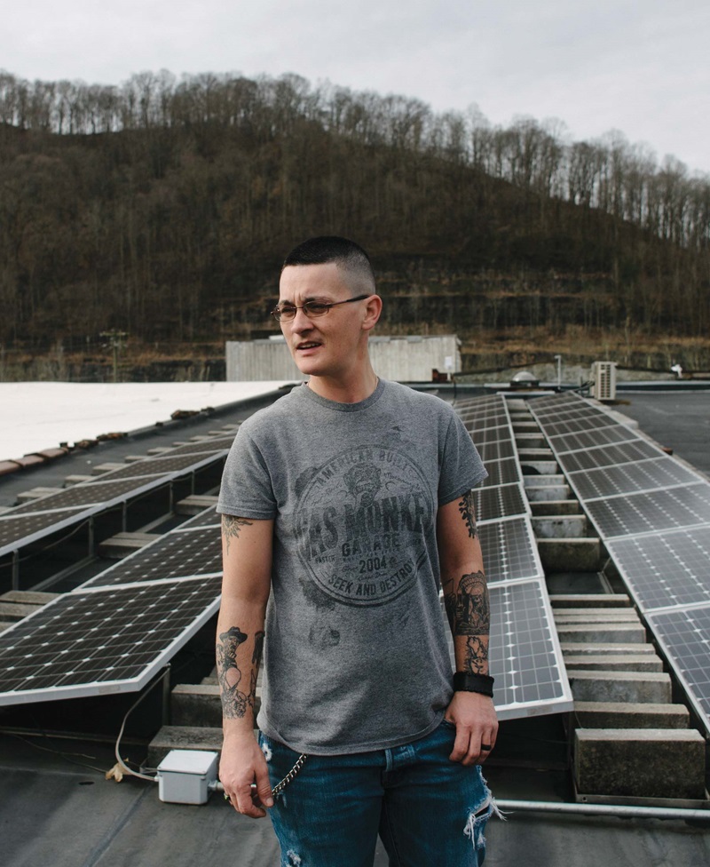Woman standing in front of solar panels