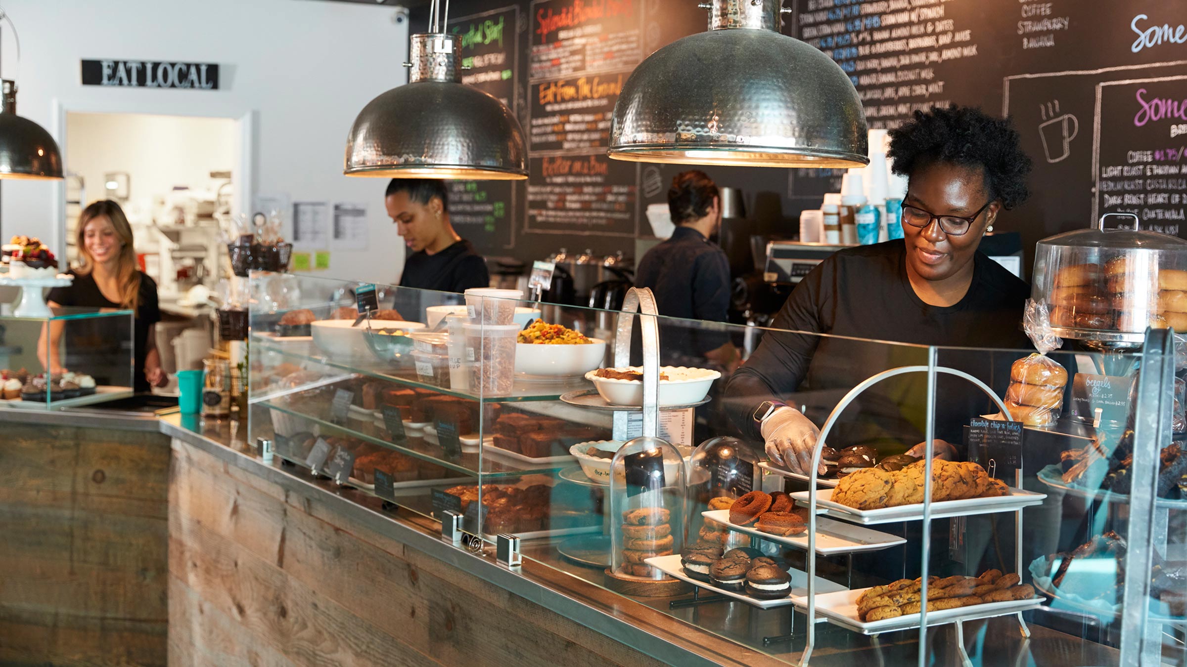 A group of employees working behind the counter at a locally-owned coffee shop