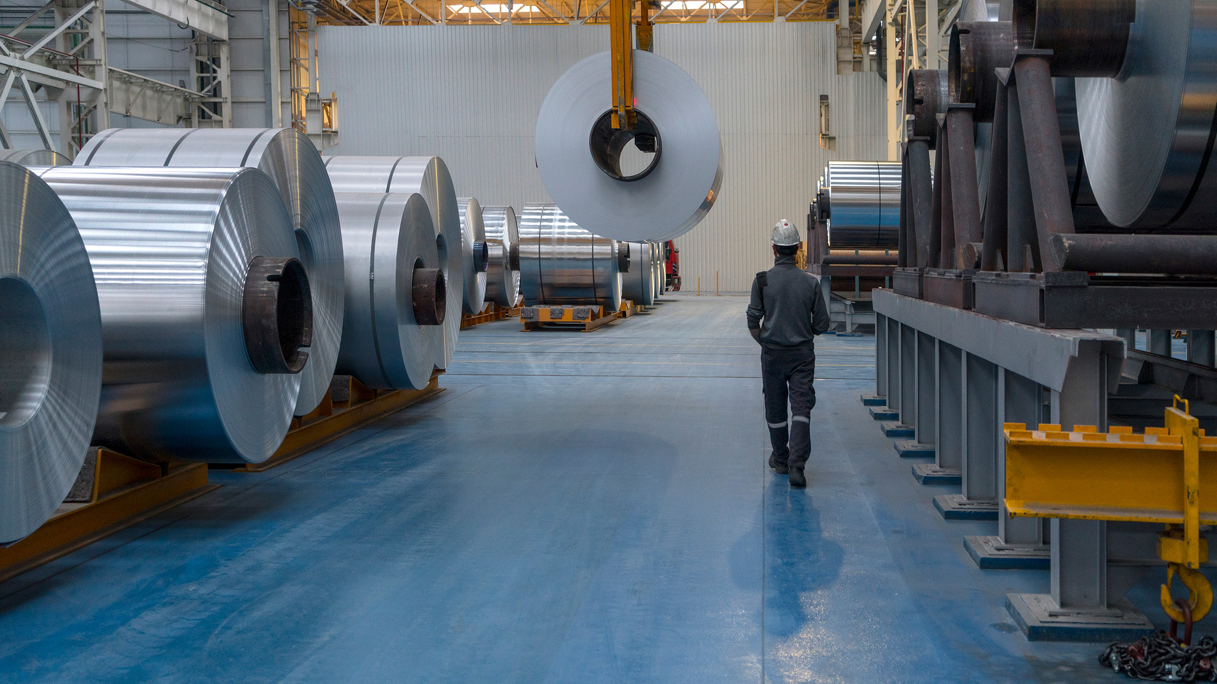 Manufacturing working walking through a warehouse