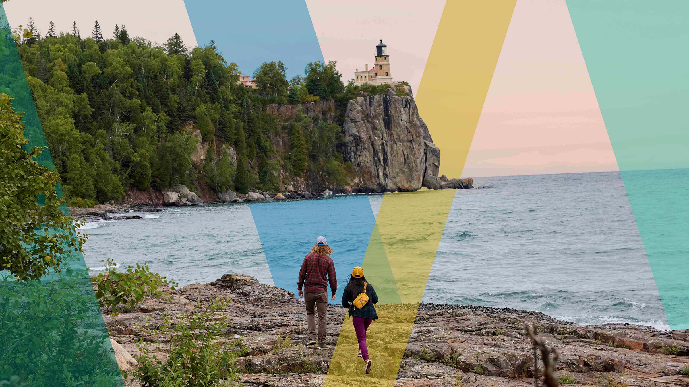 Two people hiking near the Lake Superior Lighthouse