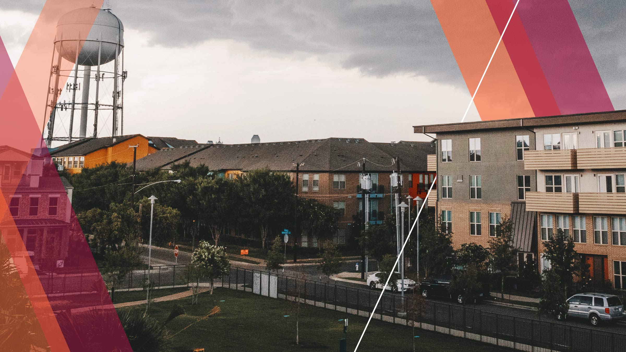 A view of a residential neighborhood in an urban community in Middle America as storm clouds gather in the sky. A park space is seen in the foreground and a mix of apartment buildings and a water tower are visible in the background. Colored bars in shades of red and orange overlay parts of the image, as a design element.