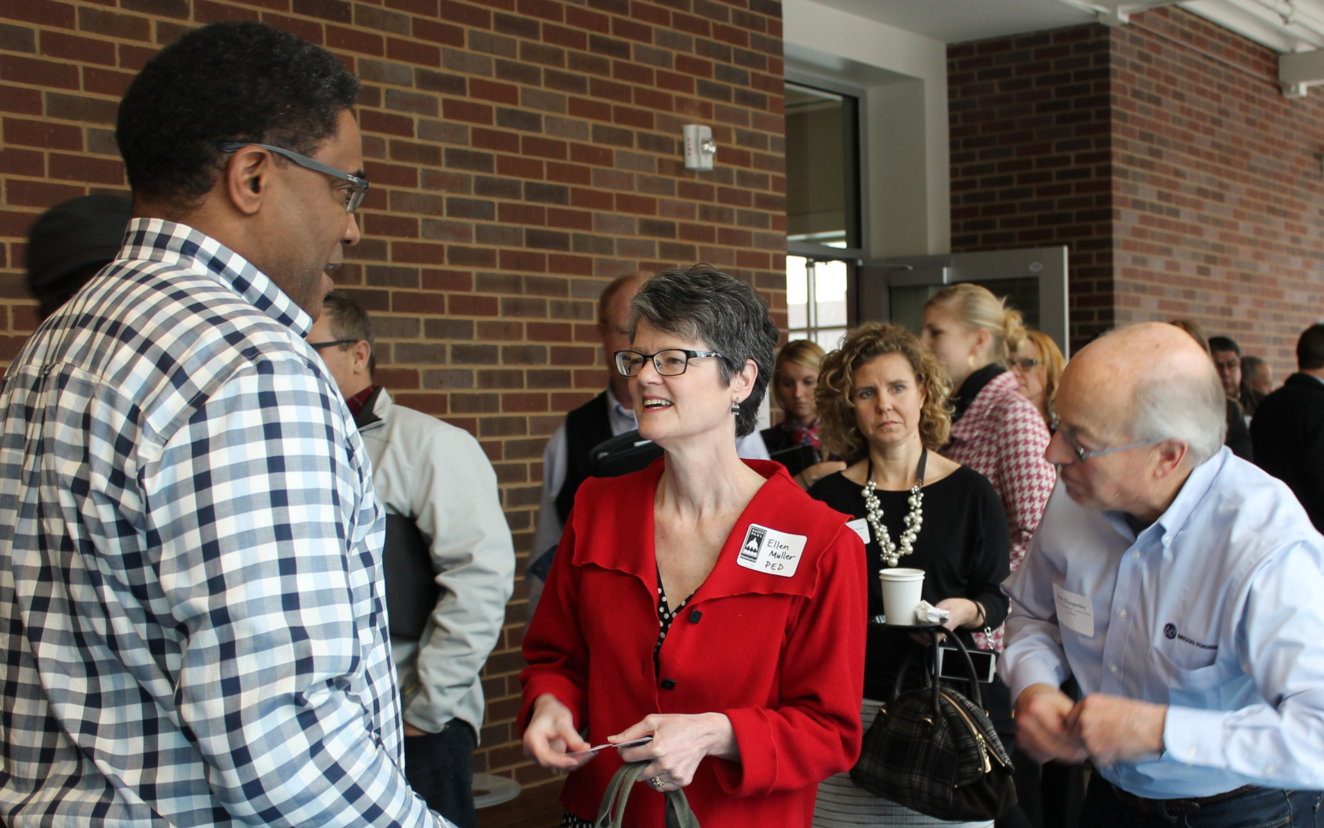 At a procurement fair in St. Paul, Minn., on January 20, Ellen Muller of the City of St. Paul's Planning and Economic Development Department (center) encourages small business owners to expand their access to government contracting opportunities by registering with the Central Certification, or CERT, Program.