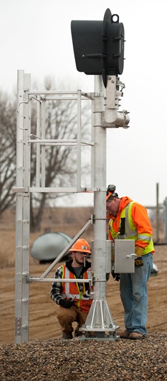 Workers installing CTC on a Canadian Pacific line in North Dakota.
