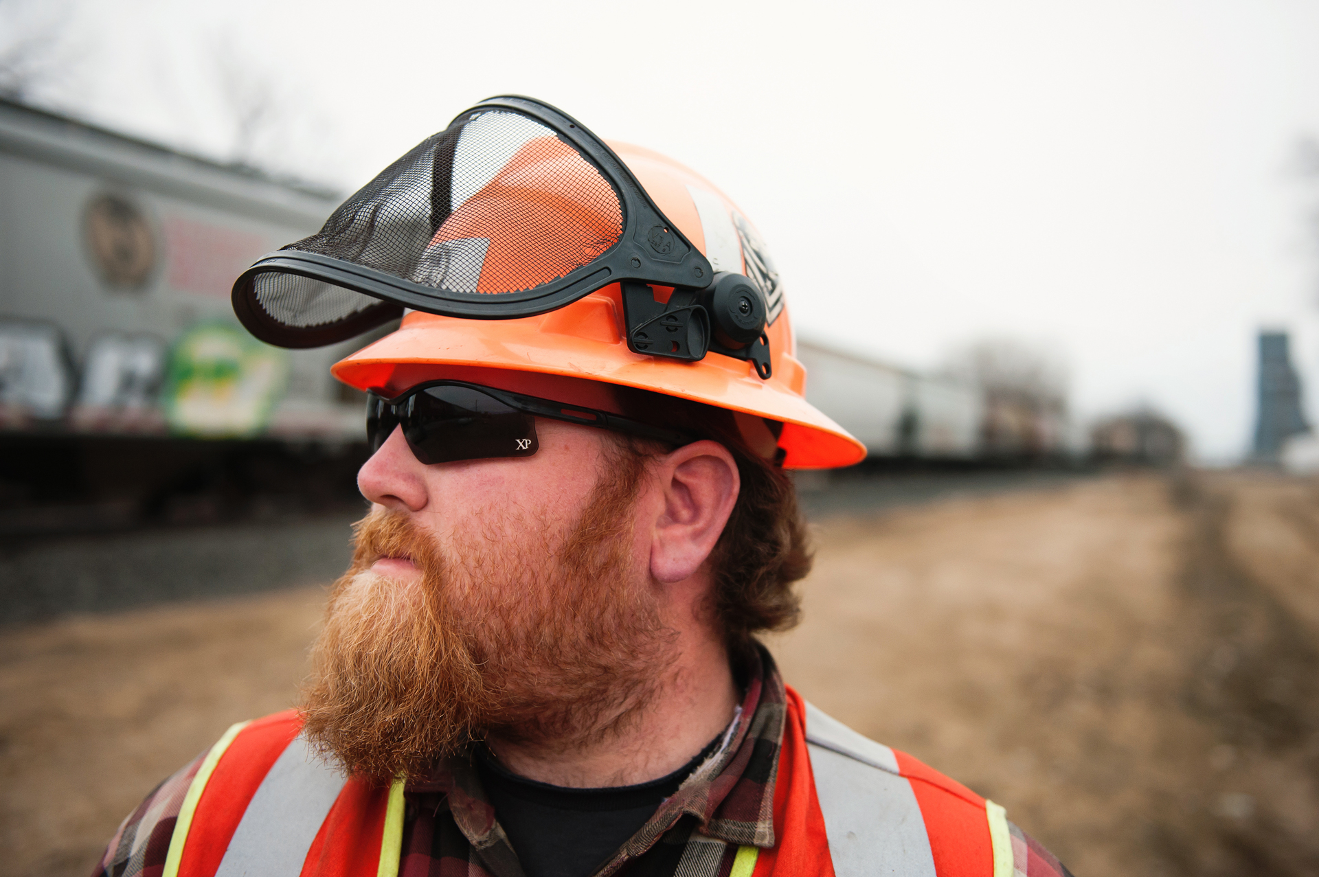 Canadian Pacific engineering employee Eric Lundon inspects a passing train at Wyndmere, N.D.