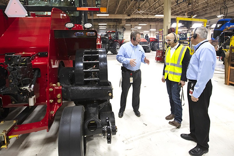 Photo of Neel touring a CNH Industrial plant